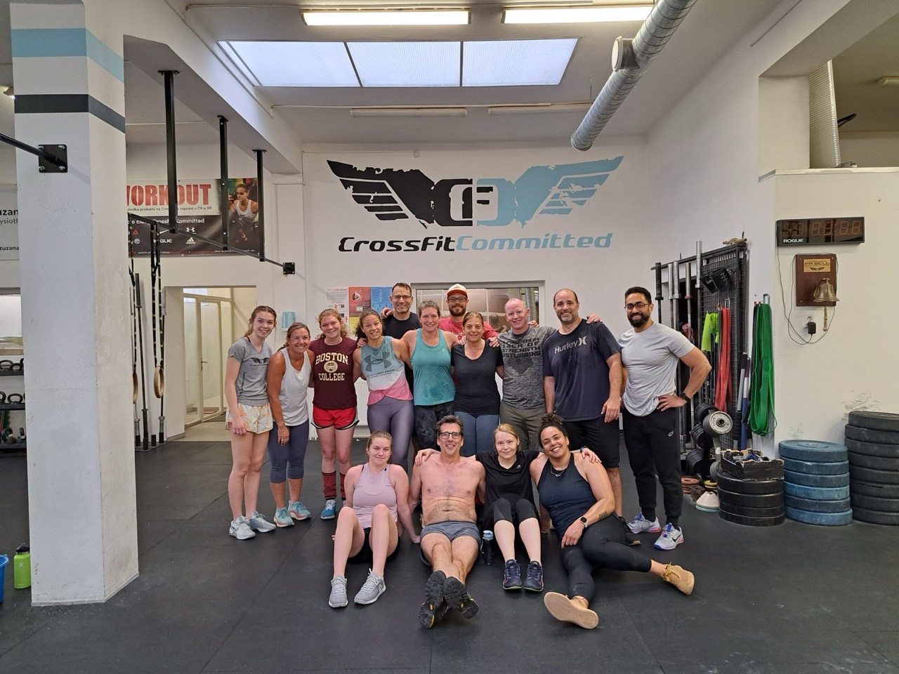 Members posing together under the CrossFit Committed logo after a class