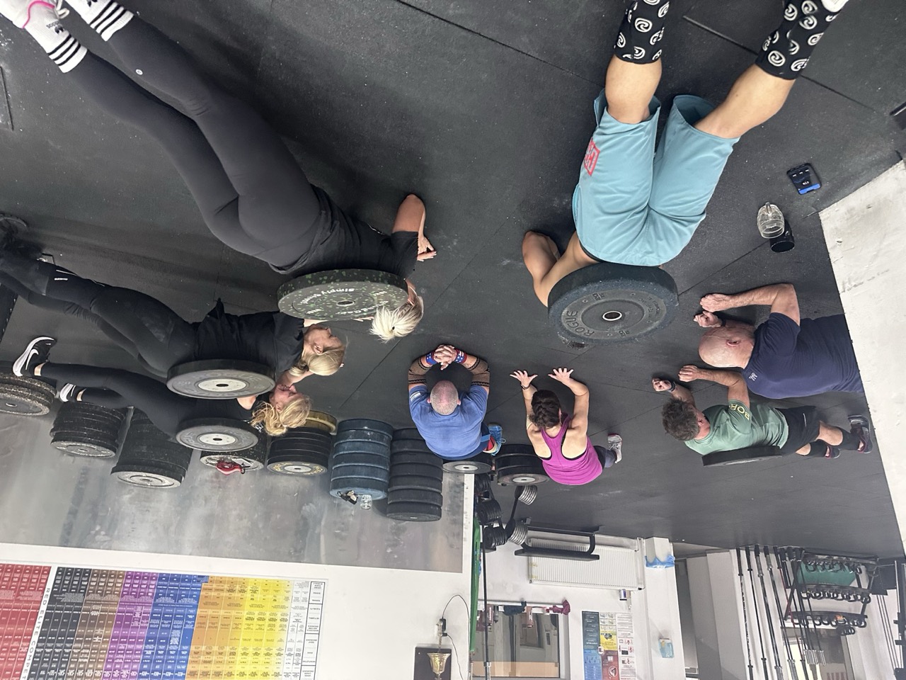 The whole class holding a plank together on the training floor
