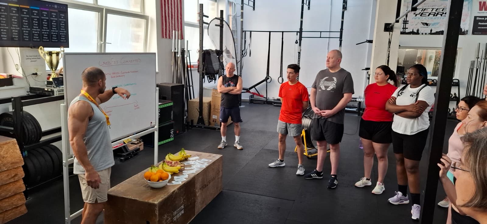 Joey coaching at the whiteboard in front of a group of members