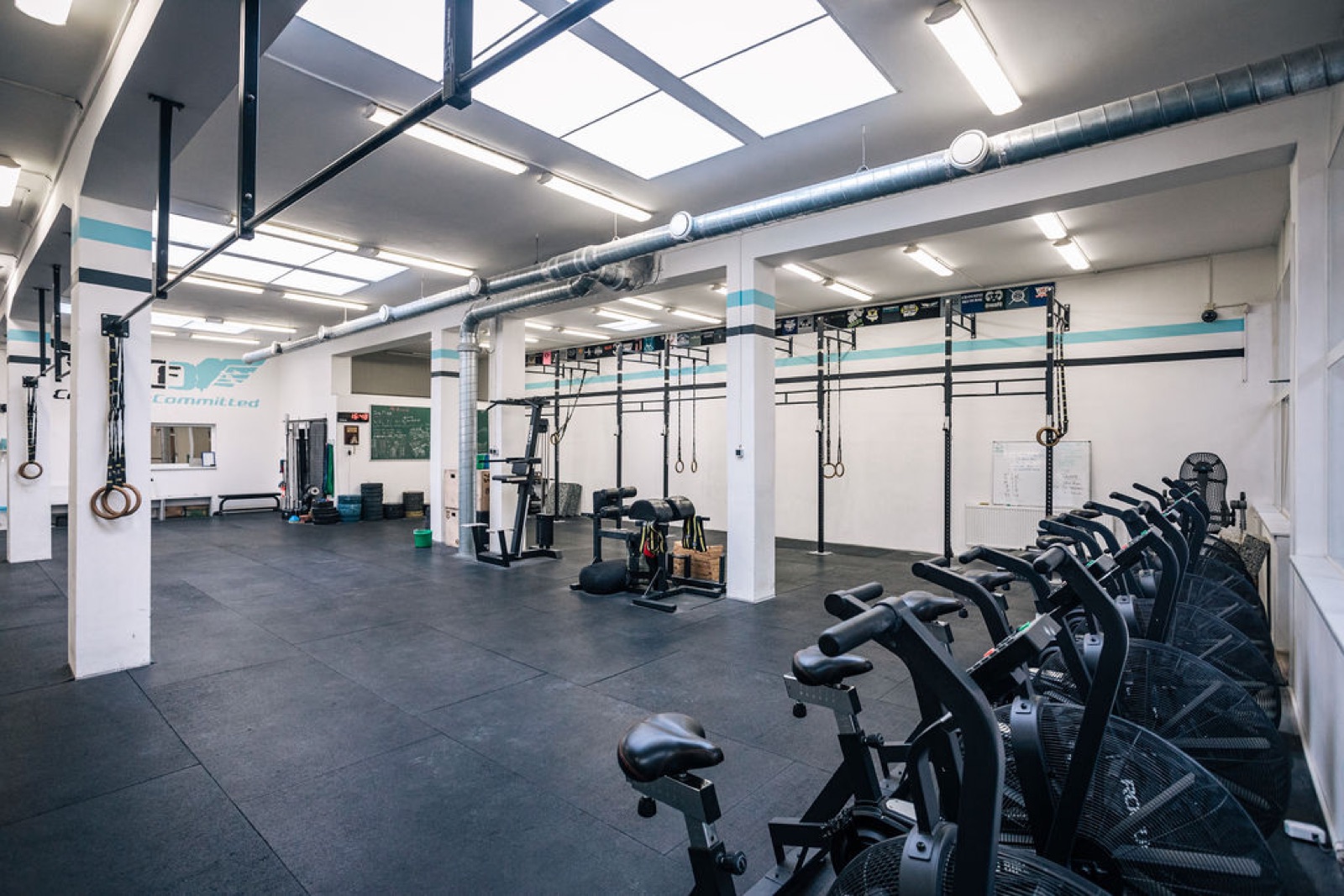 The main training floor at CrossFit Committed: rigs, bikes and open space